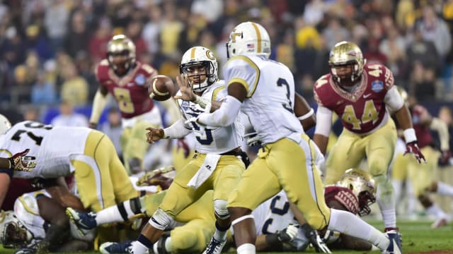 Dec 6, 2014; Charlotte, NC, USA; Georgia Tech Yellow Jackets quarterback Justin Thomas (5) pitches the ball to running back Dennis Andrews (3) in the second quarter at Bank of America Stadium. Mandatory Credit: Bob Donnan-USA TODAY Sports